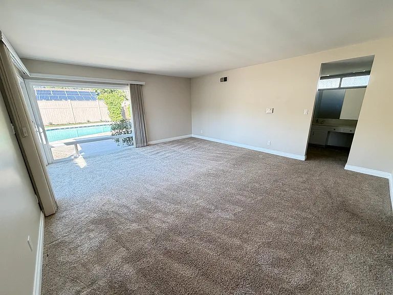 Primary bedroom with pool view