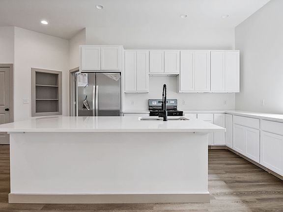 Gorgeous sun filled kitchen with TONS of counter space and natural light. Microwave will be getting installed over the stove.