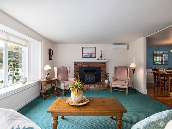 Formal living room with fireplace & insert.  Box bay front window.>