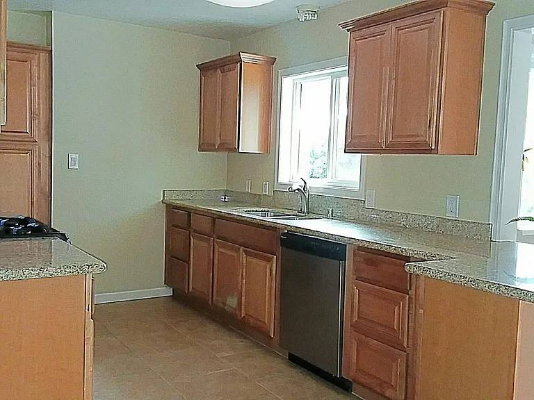 Kitchen with tons of cabinet space and stanless steel dishwasher, gas oven and overhead microwave