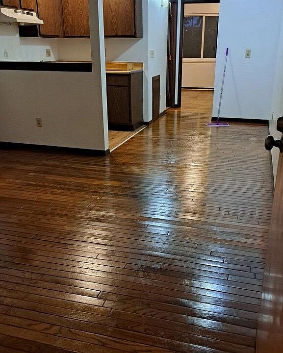 View from your front door into the apartment. Large living area with hardwood floors.