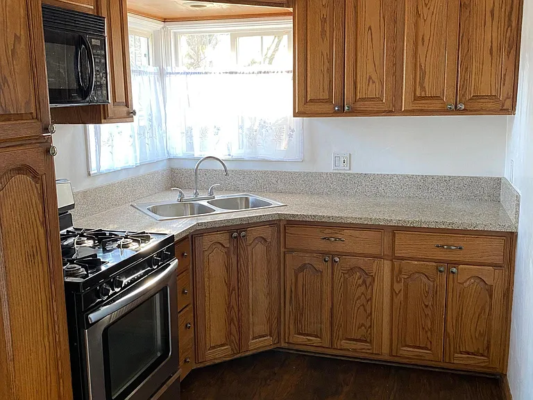 Kitchen with microwave, gas stove with four burners, and garbage disposal. Refrigerator provided
