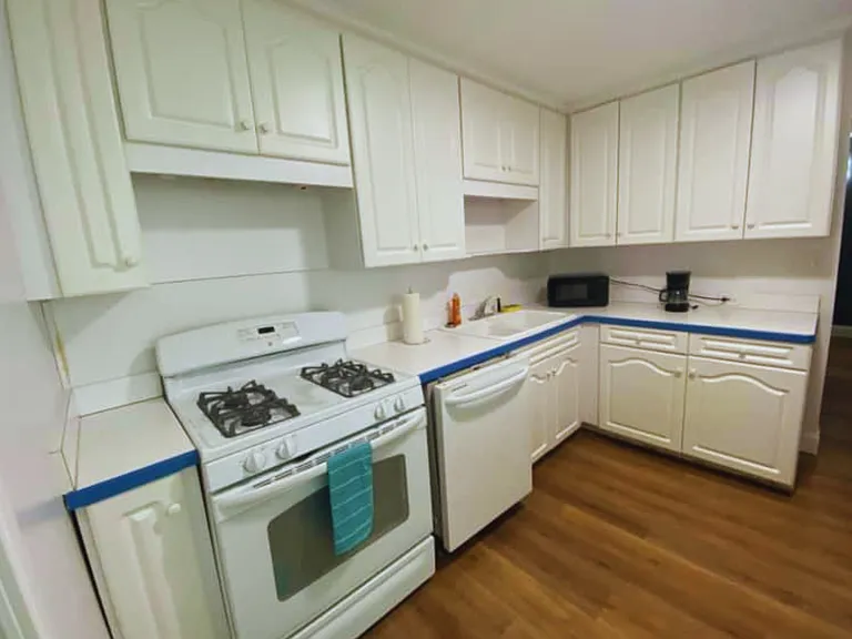 Fully equipped kitchen featuring a stove, oven, microwave, refrigerator and cabinetry.