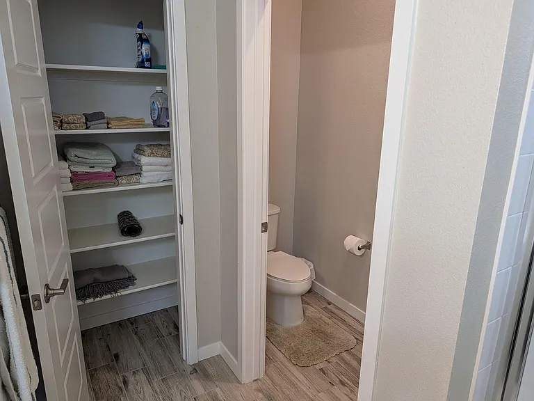 Primary bedroom bathroom and linen