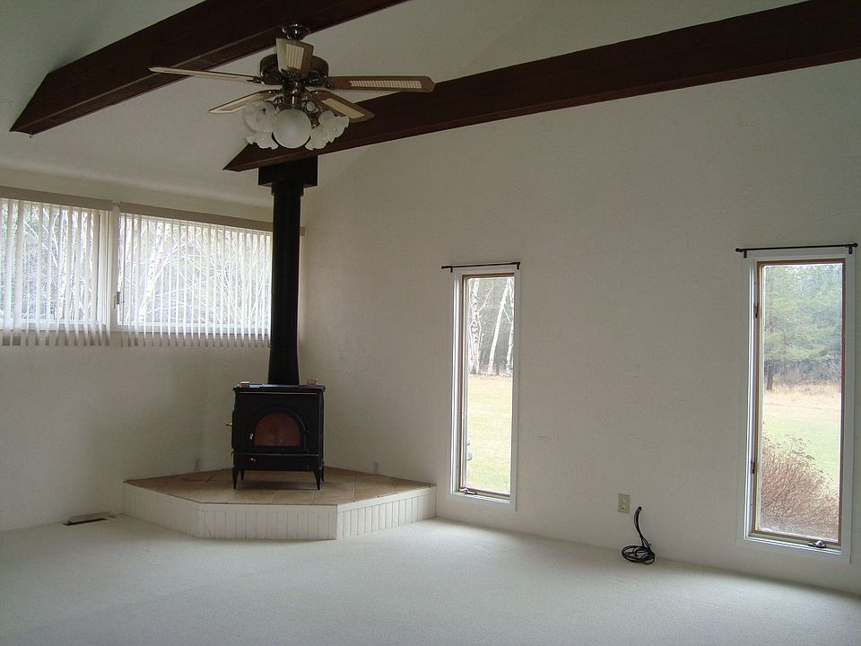Living room with vaulted ceilings and wood stove
