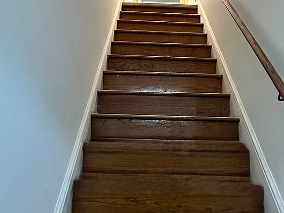 FRONT DOOR STAIRS : Original Wood, stairs leading to first floor living area ; half BR, kitchen, family living room, kitchen, BACK DOOR stairs to parking lot.