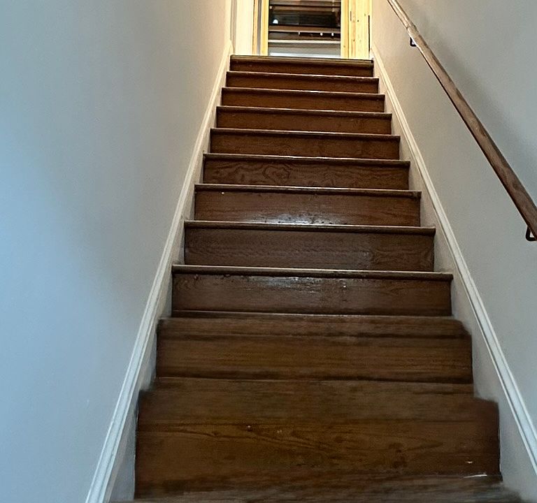 FRONT DOOR STAIRS : Original Wood, stairs leading to first floor living area ; half BR, kitchen, family living room, kitchen, BACK DOOR stairs to parking lot.