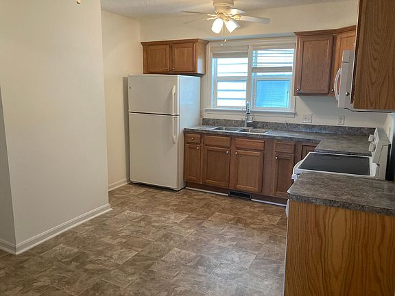 Large, eat-in kitchen. Freshly painted. Ceiling fans, microwave, oven, and refrigerator. Plenty of cabinet space.