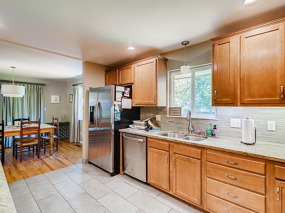 Kitchen opens to dining area with views of the covered patio and private back yard.
