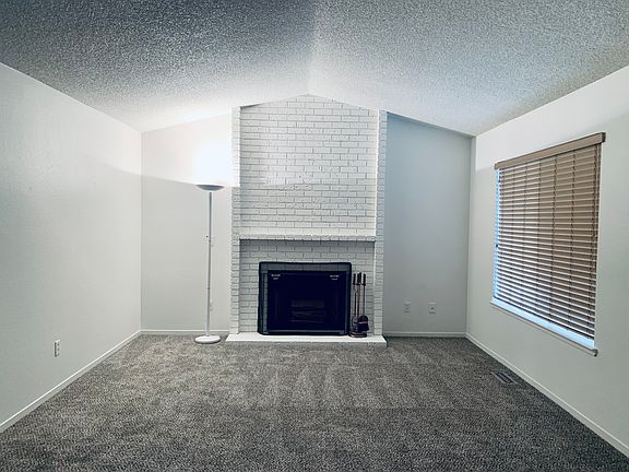 Living room with wood burning fireplace.