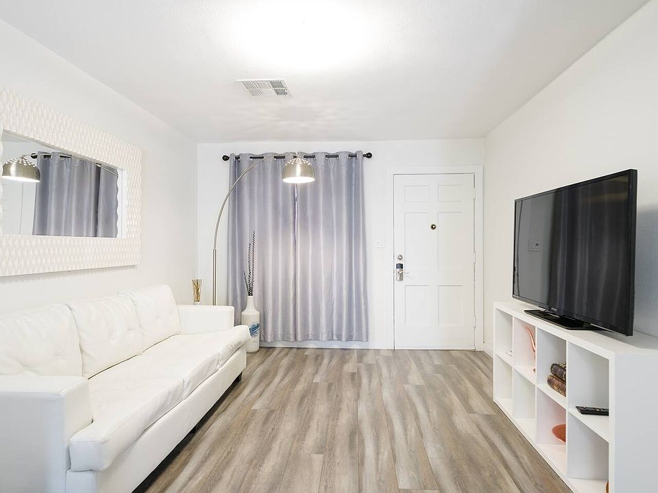 Spacious living room with modern furniture and new wood laminate floor throughout the bungalow.