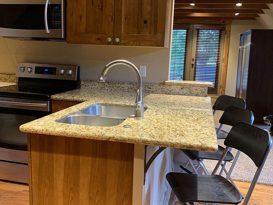 Kitchen island with french doors to deck in background.