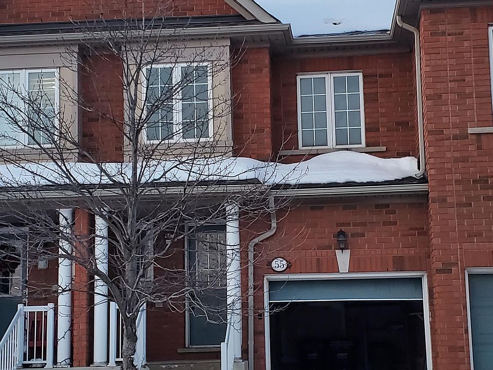 Front view of the townhouse along with its open garage.