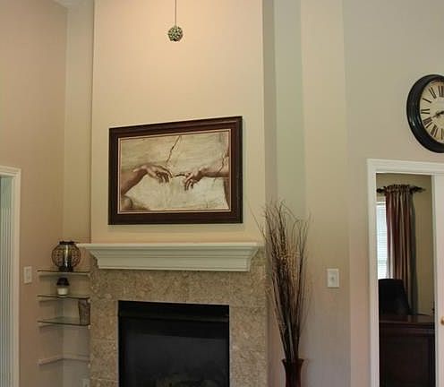 Two sided fireplace with great room and den/office