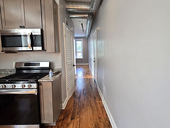 Hallway leading to bathroom and living room