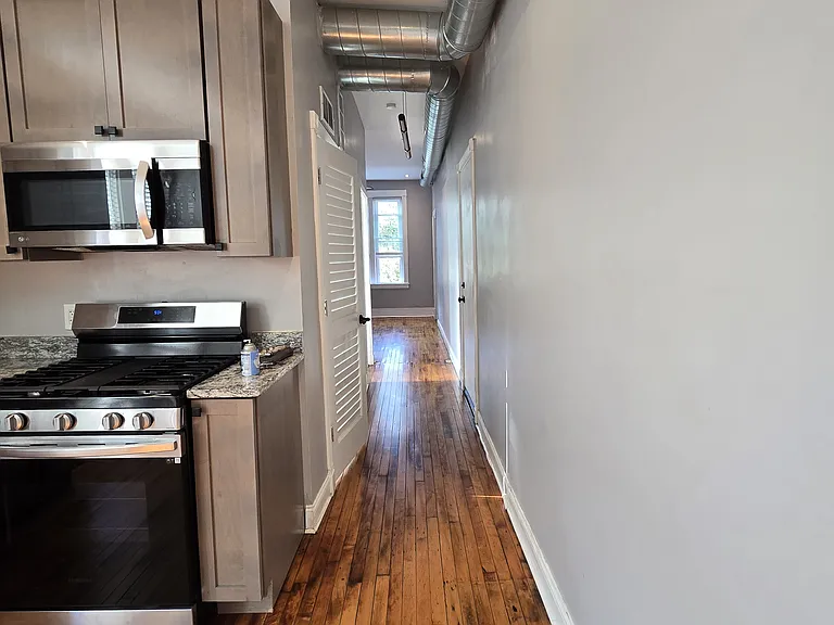 Hallway leading to bathroom and living room