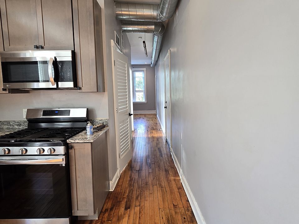 Hallway leading to bathroom and living room
