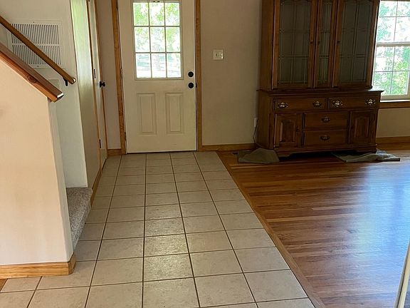 Entryway into formal dining room with access to bedrooms upstairs, kitchen and large family room