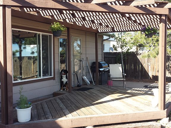 Pergola-covered rear deck.