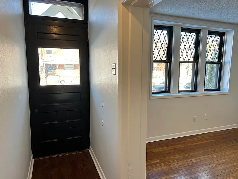 Front door & entryway, leading into the living room.