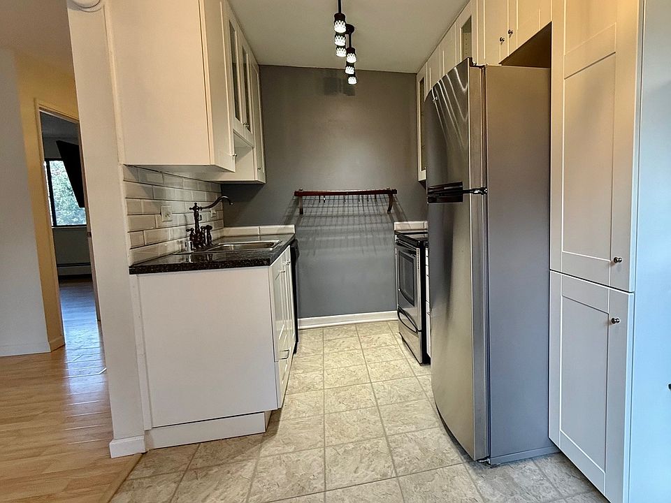 Modern kitchen with stainless steel appliances. Ample cabinet space.