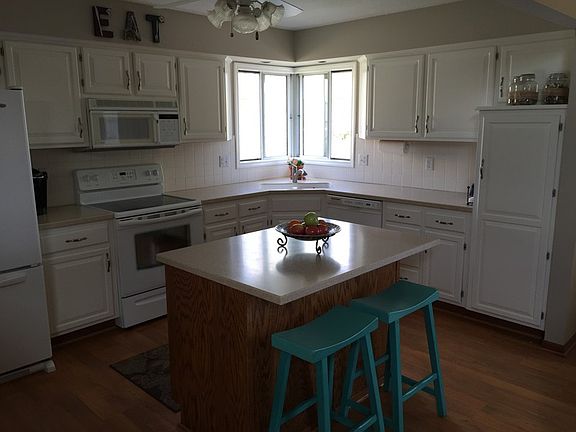 solid surface counters, huge island, updated cabinets, maintenance free flooring