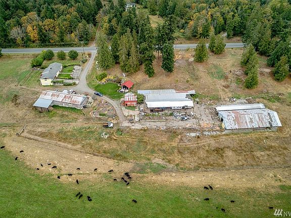 Home top left, 2880 sq foot shop below it, 400 sq foot bbq hang out area is to the right of the house, at center to the right of the red barn is the 6480sq foot dry storage area, to the right is the covered equestrian arena.