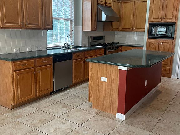 View of kitchen, with very large center island approx. 7.5ft. x 3 ft. Lots of cabinet space and large pantry.