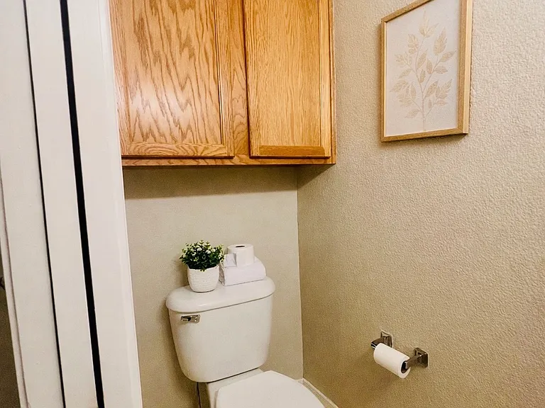 Convenient main-level half bathroom for guests, virtually staged with decor only. New LPV flooring will be installed.