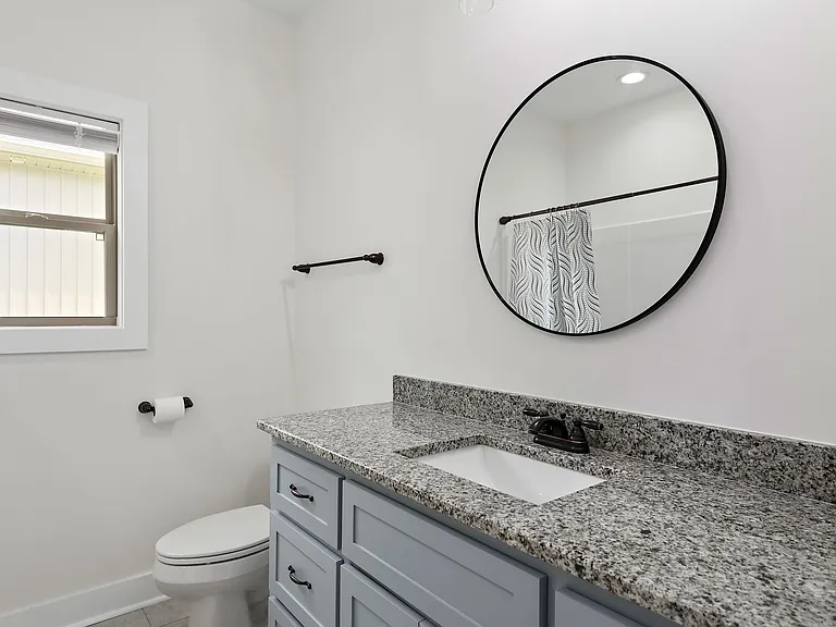 Guest full bathroom with side of house view