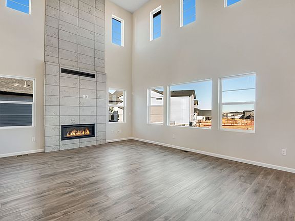 Spacious great room equipped with a sleek fireplace