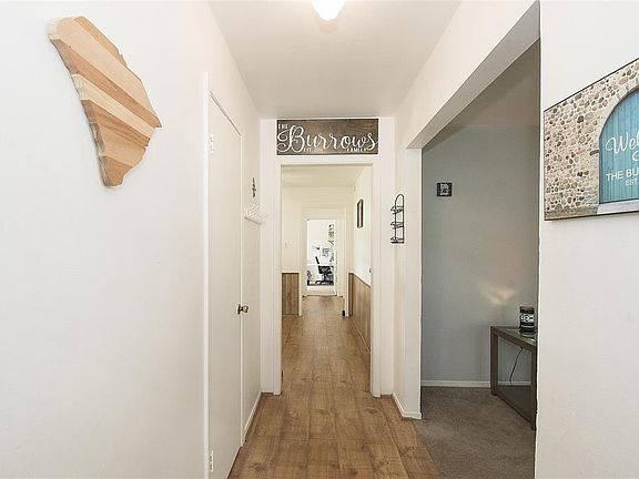 Entry to the home features beautiful laminate floors with the family room to the right.