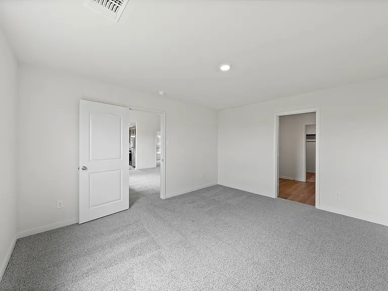 The master suite has a spacious bedroom, en-suite bathroom and walk-in closet.