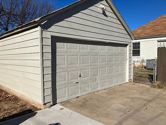large garage with extra storage space behind it