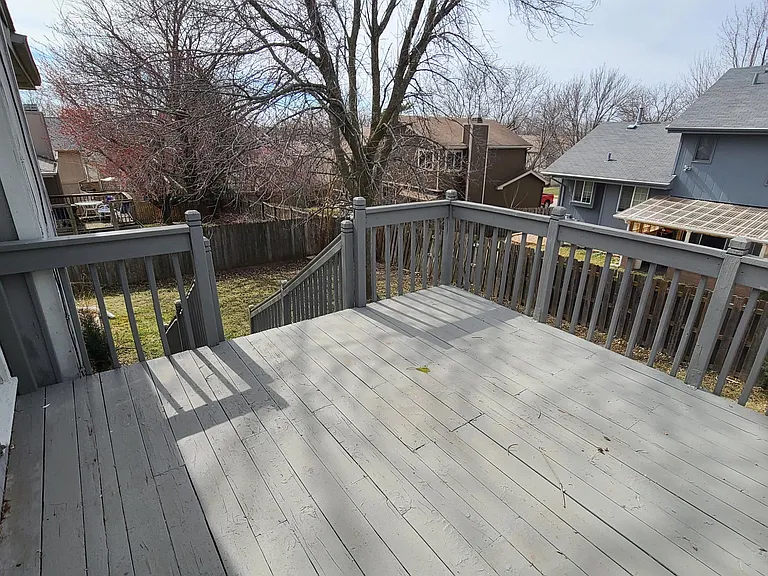 Extra large painted deck with sliding glass doors from the kitchen