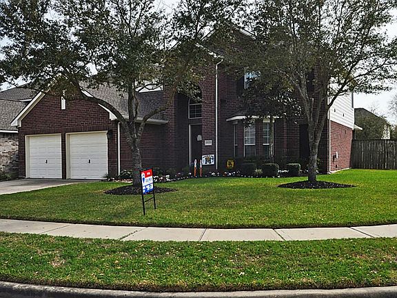 Large trees shade the front yard.