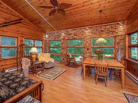 Original vaulted porch was converted into this fabulous 4-season addition with 3-sides knotty pine and one side stacked stone wi