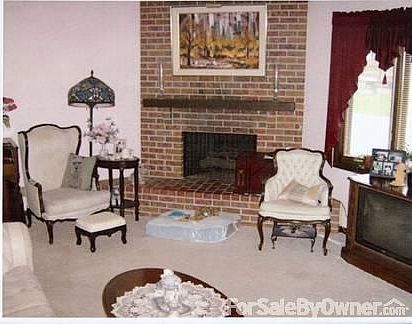 Living room w/massive brick fireplace : Living room has raised-hearth fireplace. Luxurious cream- co