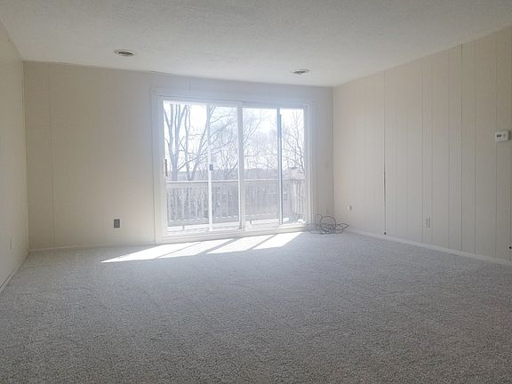 Good size living room with balcony with view overlooking woo