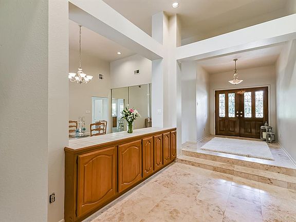 22x9 Entry - There's a skylight over this space shining natural light onto the party of food that can be displayed on the buffet which can be accessed from both sides including storage. This house is perfect for entertaining.