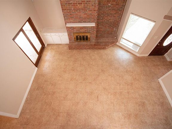 Living room with fire place and high ceiling and built-ins