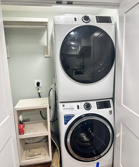 Washer dryer and clothes hanging unit in the fully renovated basement.
