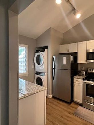 Kitchen with stackable washer and dryer. High end.