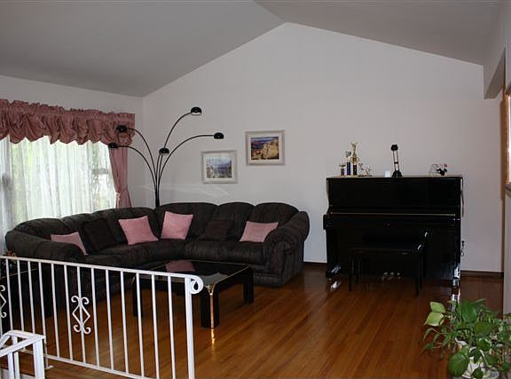 LIVING ROOM W/ HARDWOOD FLOORS, AND CATHEDRAL CEILING