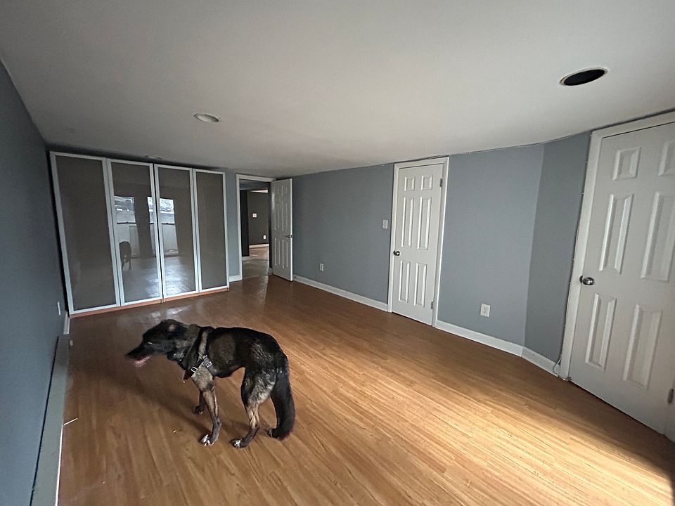 Bedroom. Windows behind looking out toward foyer.