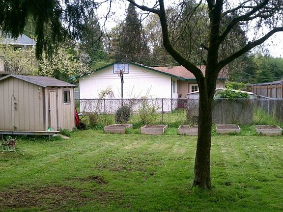 Spacious living room with skylight & large window overlooking front yard. Plenty of natural light.