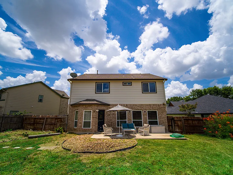 An incredible, expansive backyard entirely enclosed by a privacy fence. With endless green space, mature trees, and room for outdoor play structures, it's a paradise for pets, children, and outdoor gatherings.