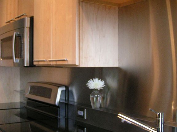 Granite counters, stainless backsplash, solid maple cabinets