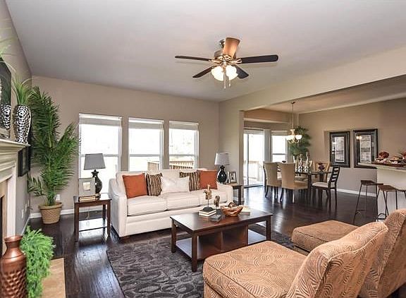 Spacious Great Room with Hardwood floors, woodburning fireplace, ceiling fan - open to kitchen area
