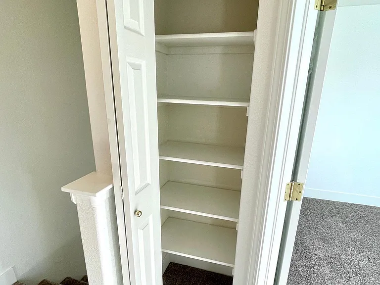 Large linen closet located at the top of stairs/landing